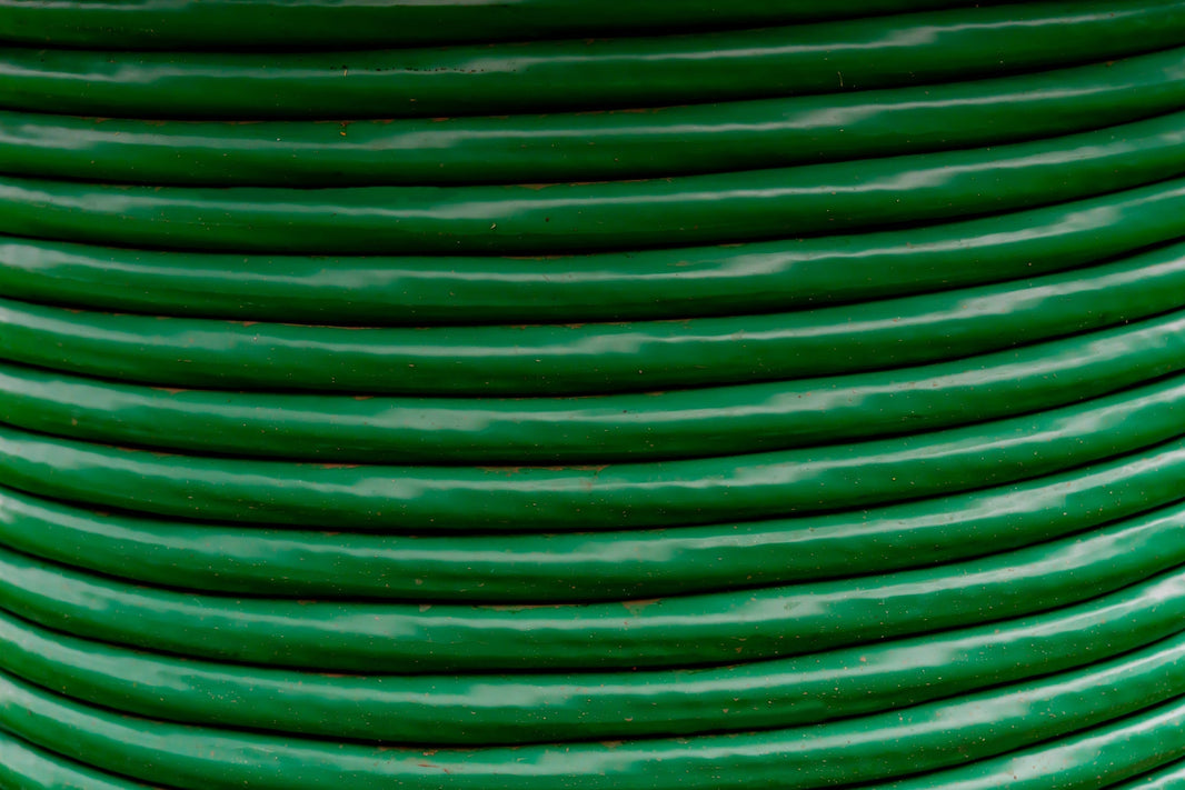 A closeup of a spool of green cable wire.